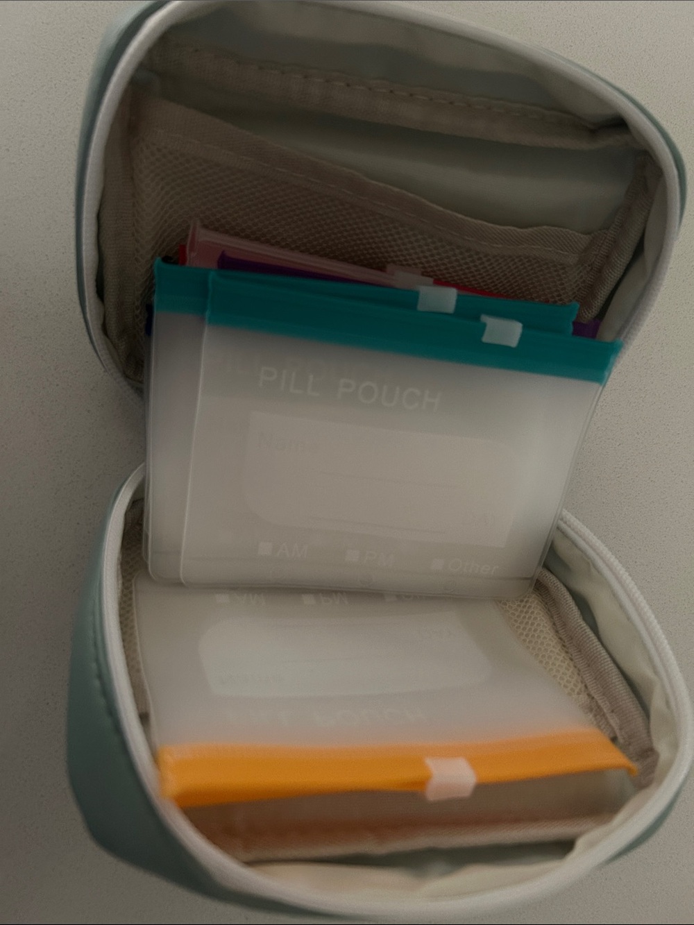 Compact White and Teal Pill Pouch Set with Color-Coded Inserts